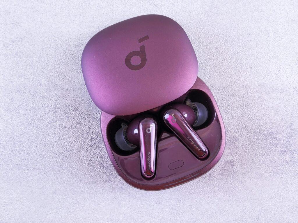 Modern purple earbuds resting in an open case, featuring glossy finish and sleek design.